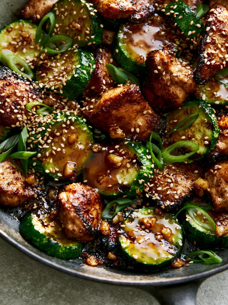 Chicken Zucchini Stir Fry: The Ultimate 20-Minute Garlic Soy Glaze Dinner 1 Macro view of caramelized minced garlic and sesame seeds on a Chicken Zucchini Stir Fry.