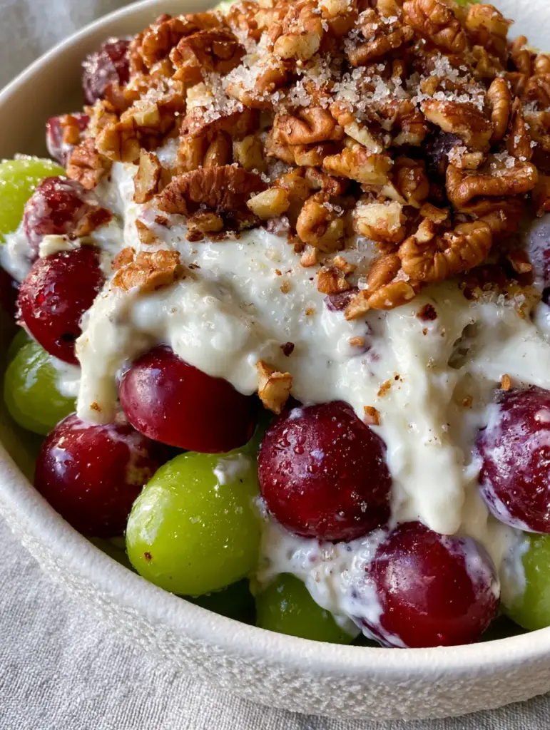 Top-down view of Grape Salad covered in a crown of golden-toasted pecans and sparkling sugar.