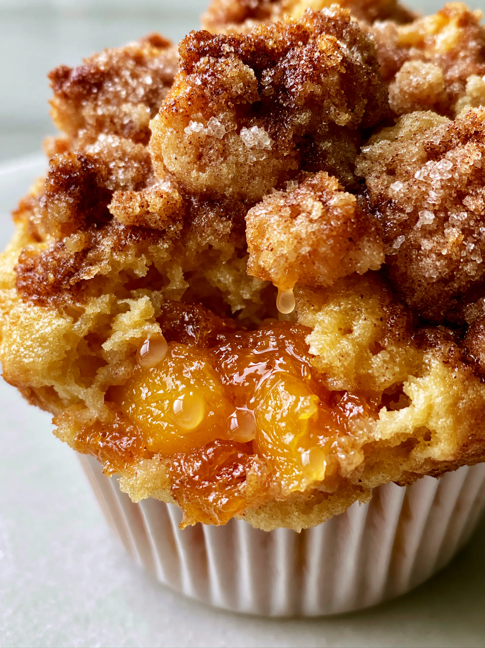 Peach Muffins with Buttery Cinnamon Streusel and Vanilla Bean 3 Macro close-up of peach muffins being pulled apart to reveal steaming moist interior and chunky peaches.