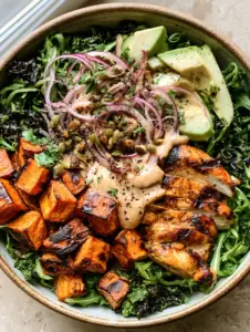 Top-down view of a Whole30 salad bowl featuring massaged kale, arugula, and seared chicken strips. (Whole30 salad bowl)