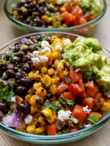 Macro photography of a Loaded Cowboy Salad showing the shimmer of the lime vinaigrette on fire-roasted corn and glossy black beans.