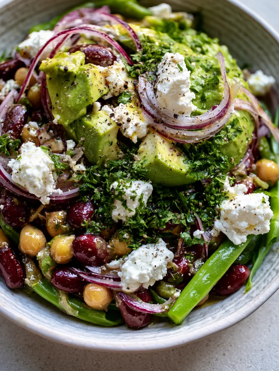 Extreme macro close-up of Three-bean diabetic-friendly salad showing glistening red kidney beans, chickpeas, and bright green beans.